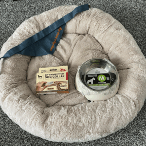 round dog bed with bowl, bandana and bottle opener